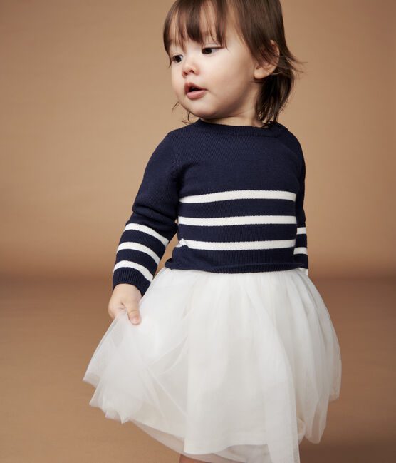 Little Girl Wearing a Blue Sweater and White Skirt