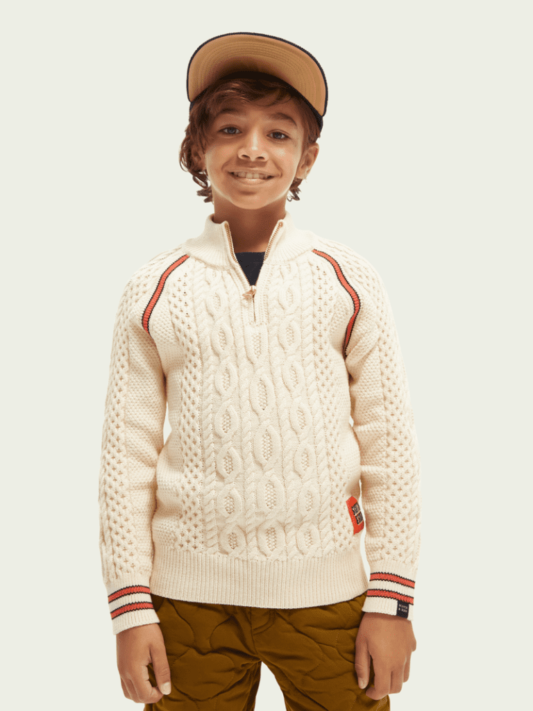 Boy Wearing a Hat in a White Sweater Front View